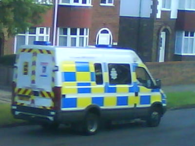 the white and yellow van has a striped blue stripe on it