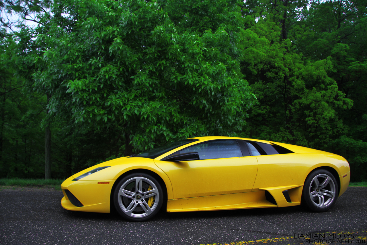 a very bright yellow lambrox car parked in the street