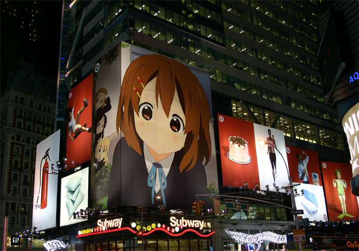 a lighted cityscape features various large anime signs