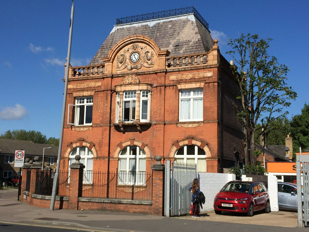 an old building with an ornate front and a car