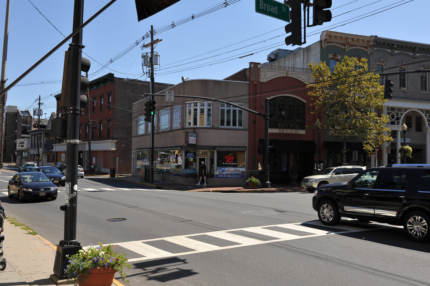 a small street with traffic and street signs and buildings