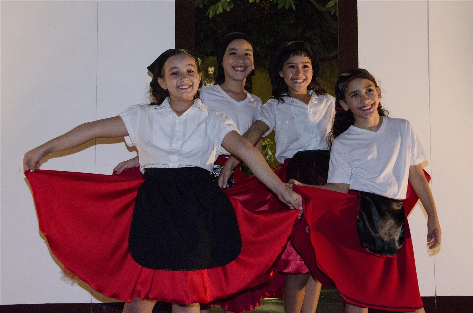 four young women pose with dresses on