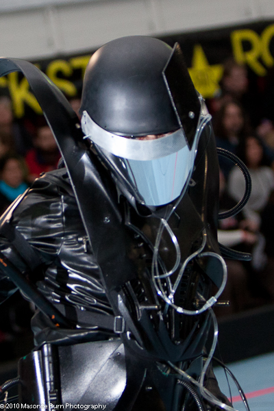 a person in a black leather suit and helmet