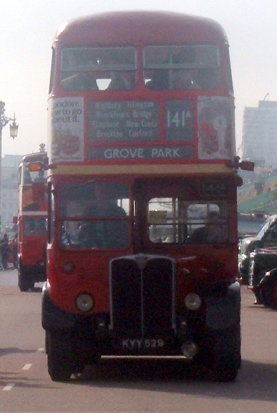 double decker buses on roadway in urban setting