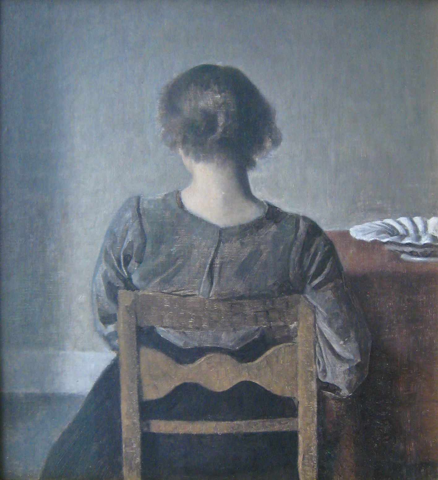 a portrait is seen of a lady sitting in a chair