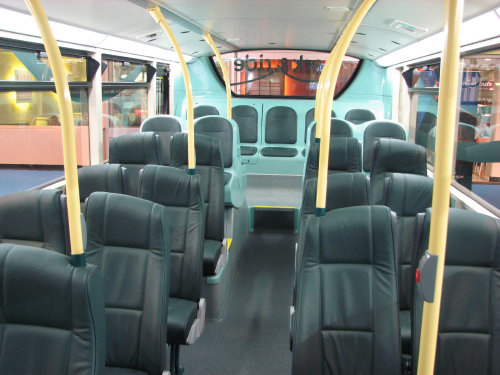 seats in a transit bus with yellow posts