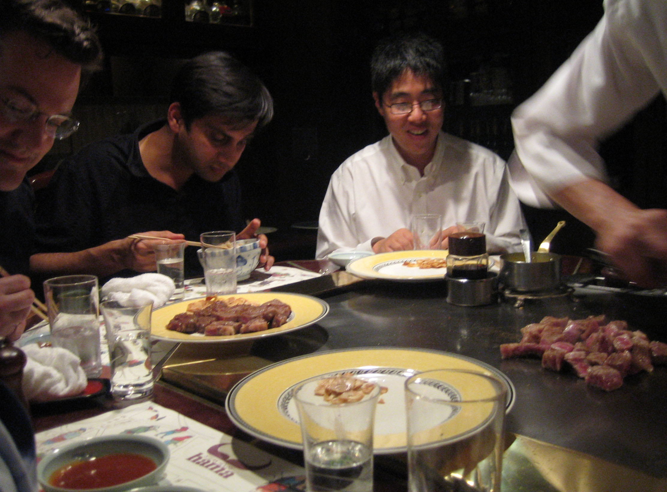 a group of friends eating dinner at a restaurant