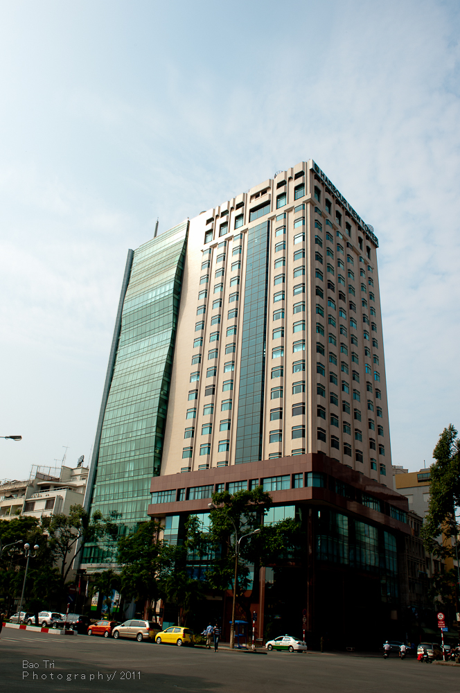 two large, tall building sit along the side of the road