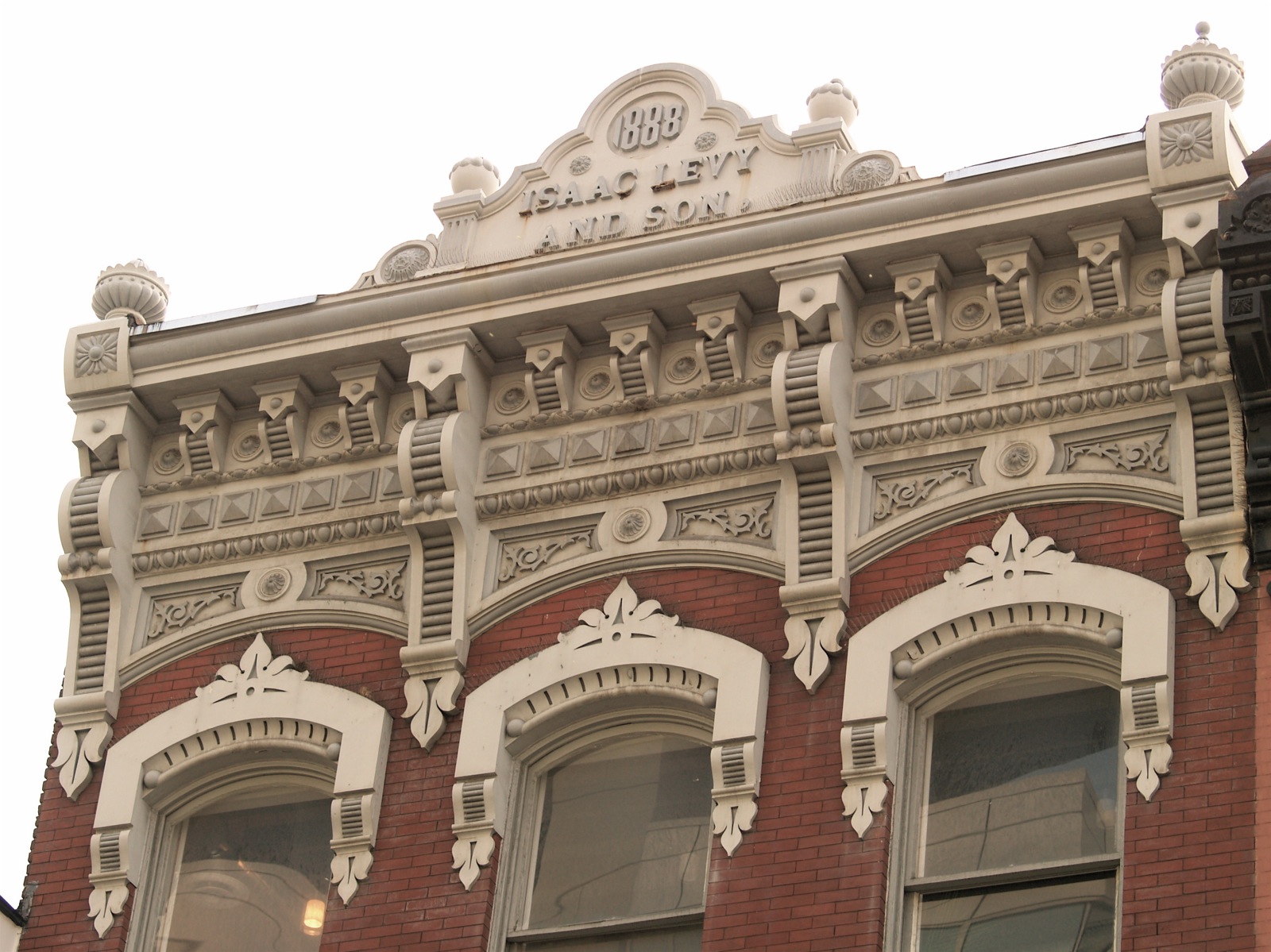 a large old brick building has ornate detailing