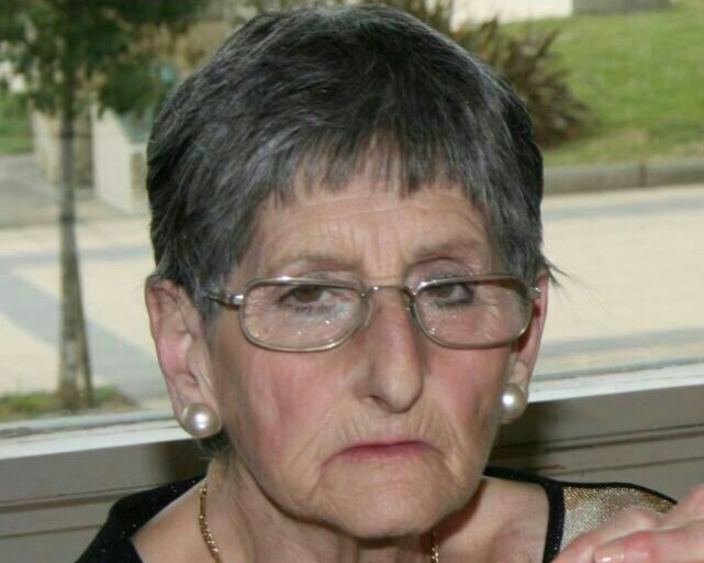 a older woman with glasses looking to her left