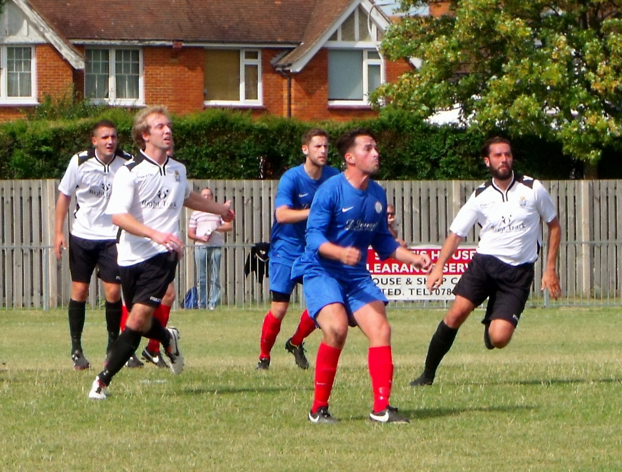 a group of men playing soccer against each other