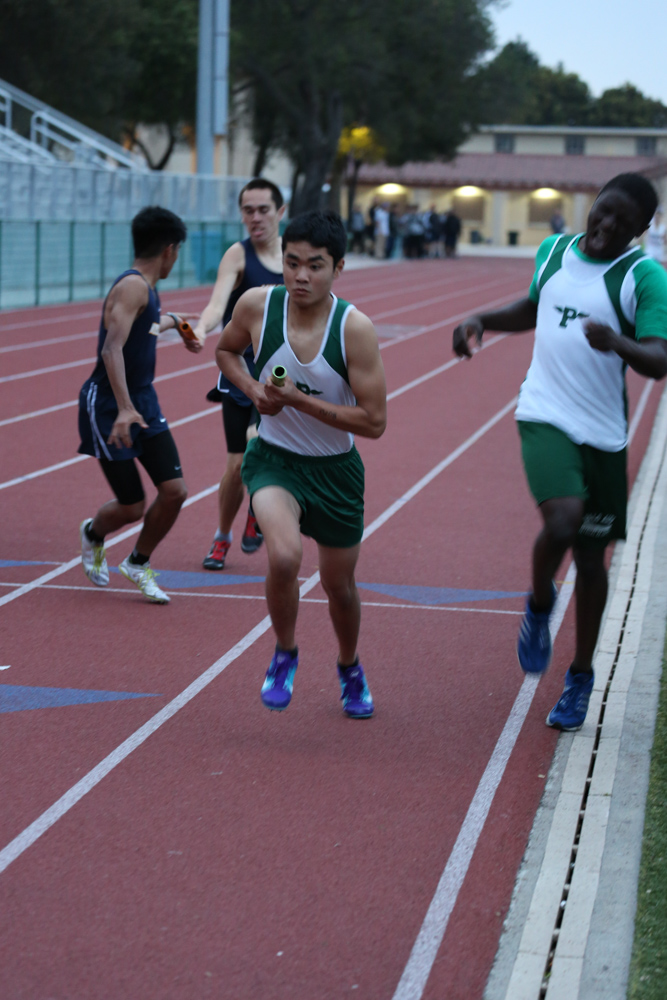 a group of boys on a race track run the length of the starting line