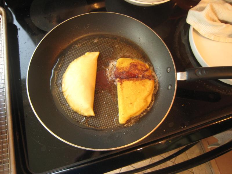 two wedges of food cooking on a pan top