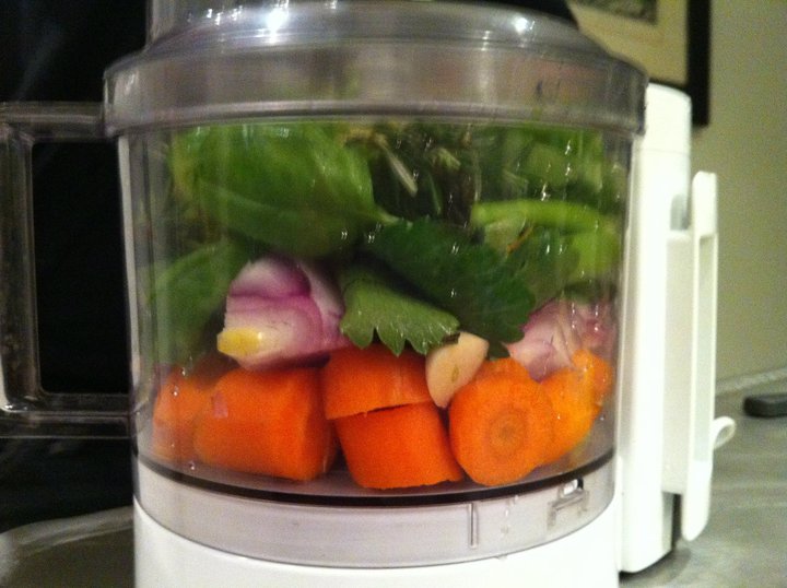 carrots, basil and spinach in a blender