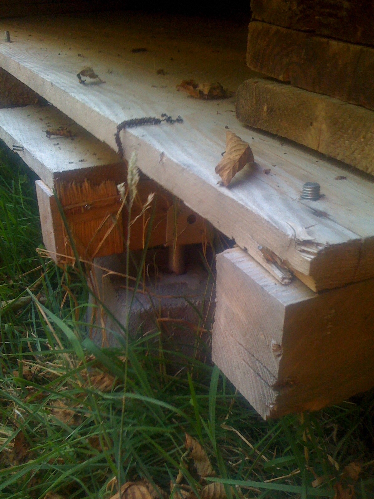 a wood bench that is laying in the grass