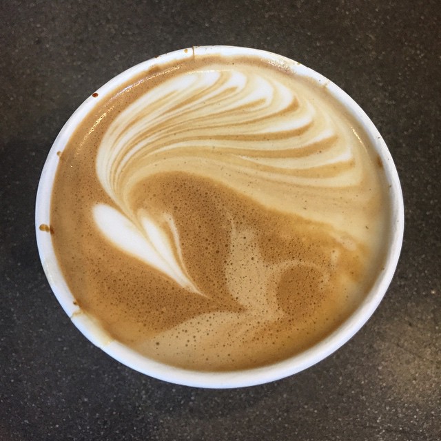 a cup of coffee with liquid on top