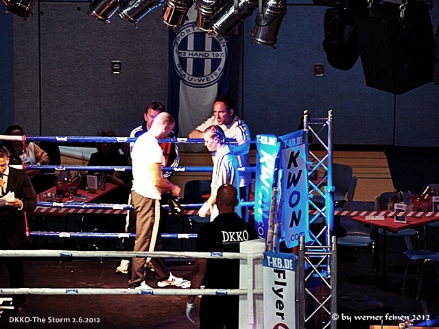 men standing next to each other on top of a boxing ring