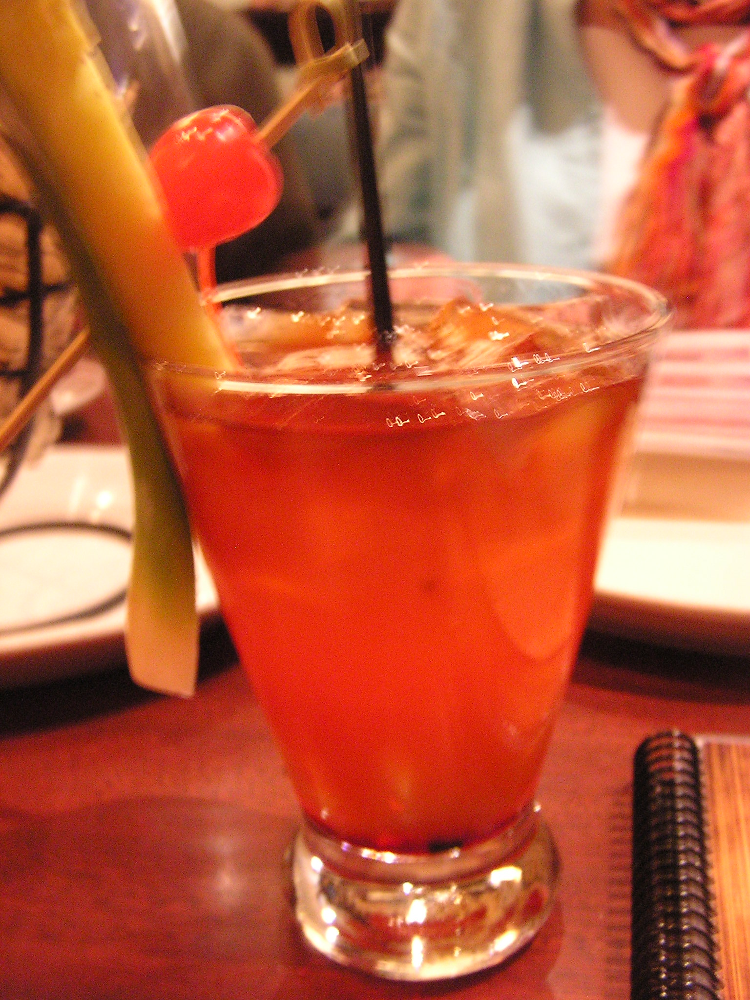 a long stemmed cocktail garnished with a red cherry
