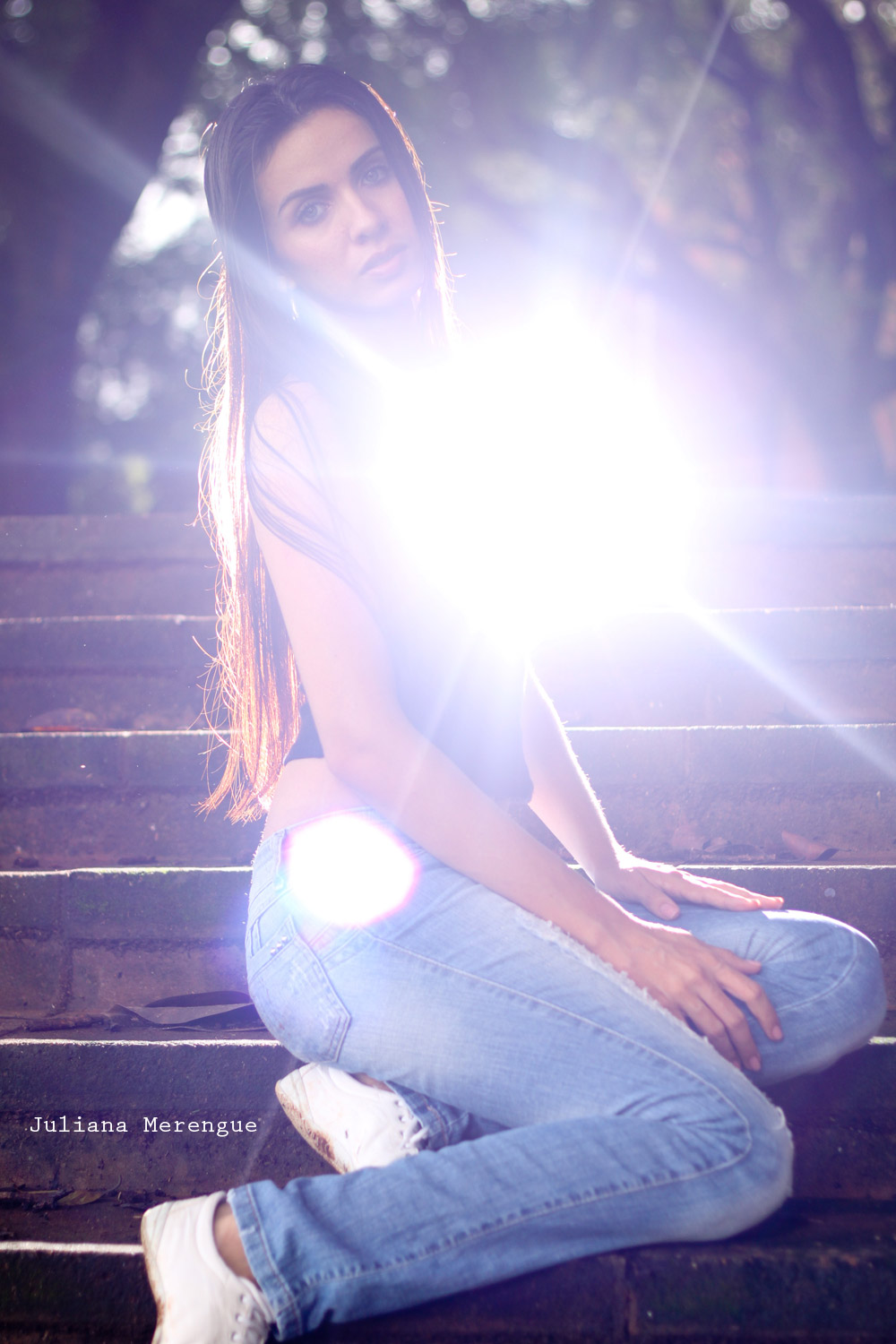 a woman sitting on the stairs with a light shining in her mouth
