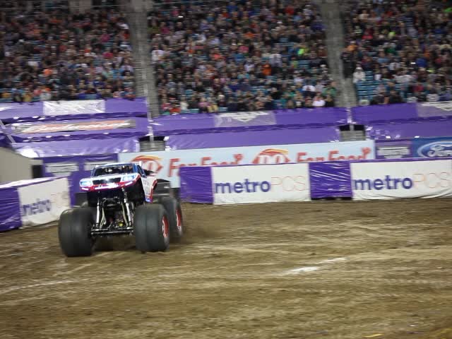 a monster truck that is standing in the dirt