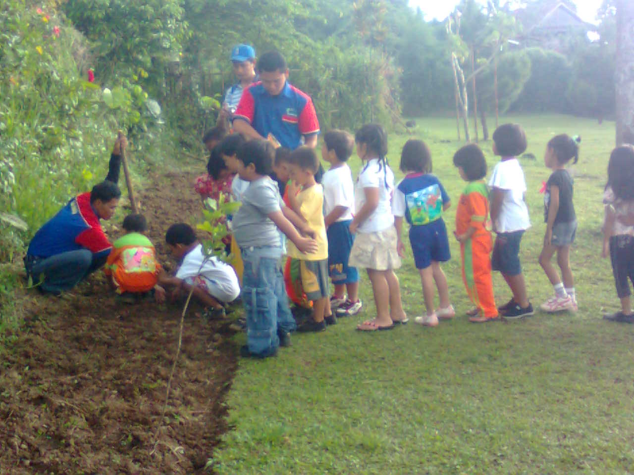 a group of children are gathering in the yard