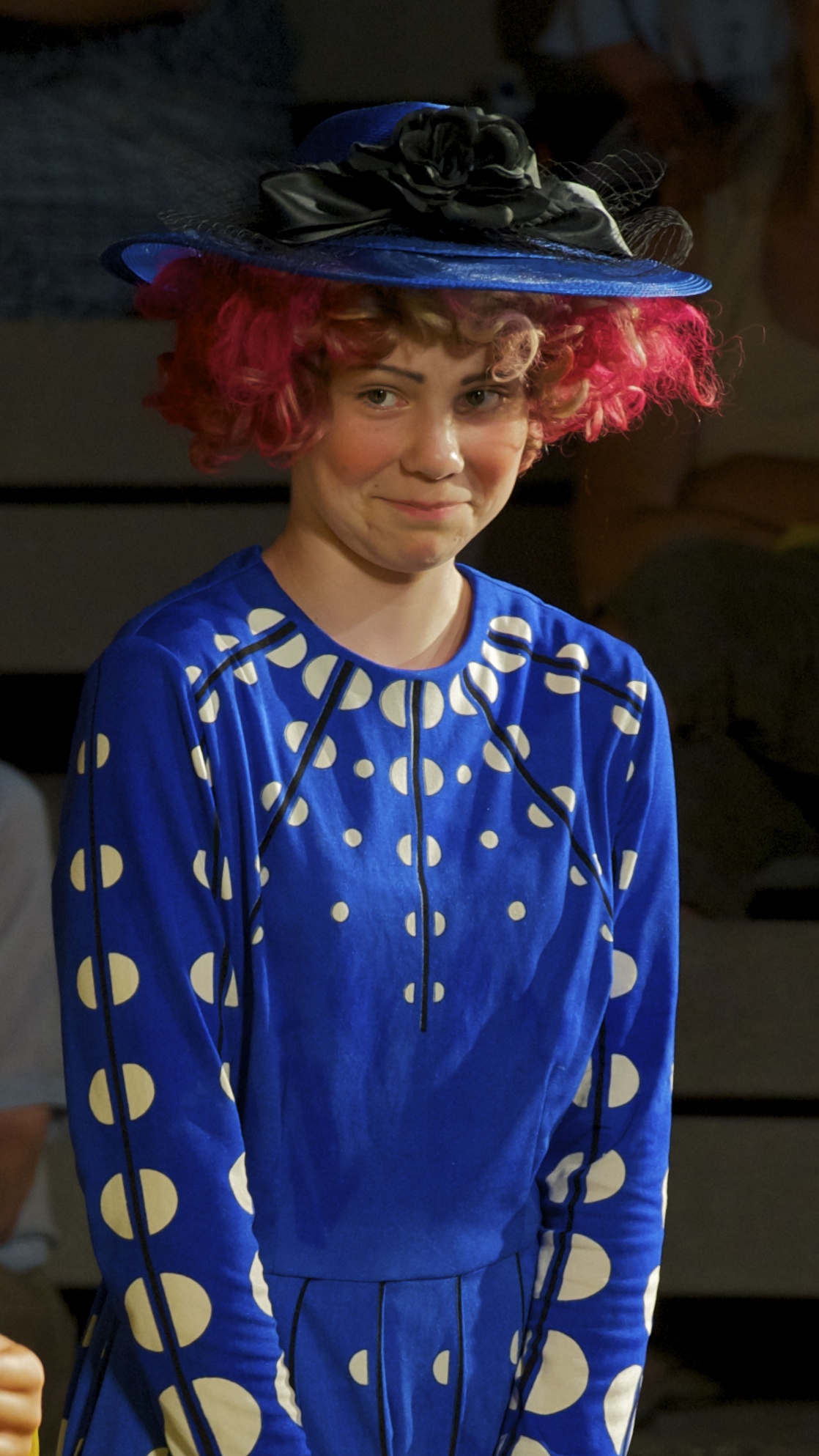 a girl with red hair wearing a blue dress