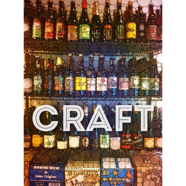 a glass wall with a bottle of craft on it