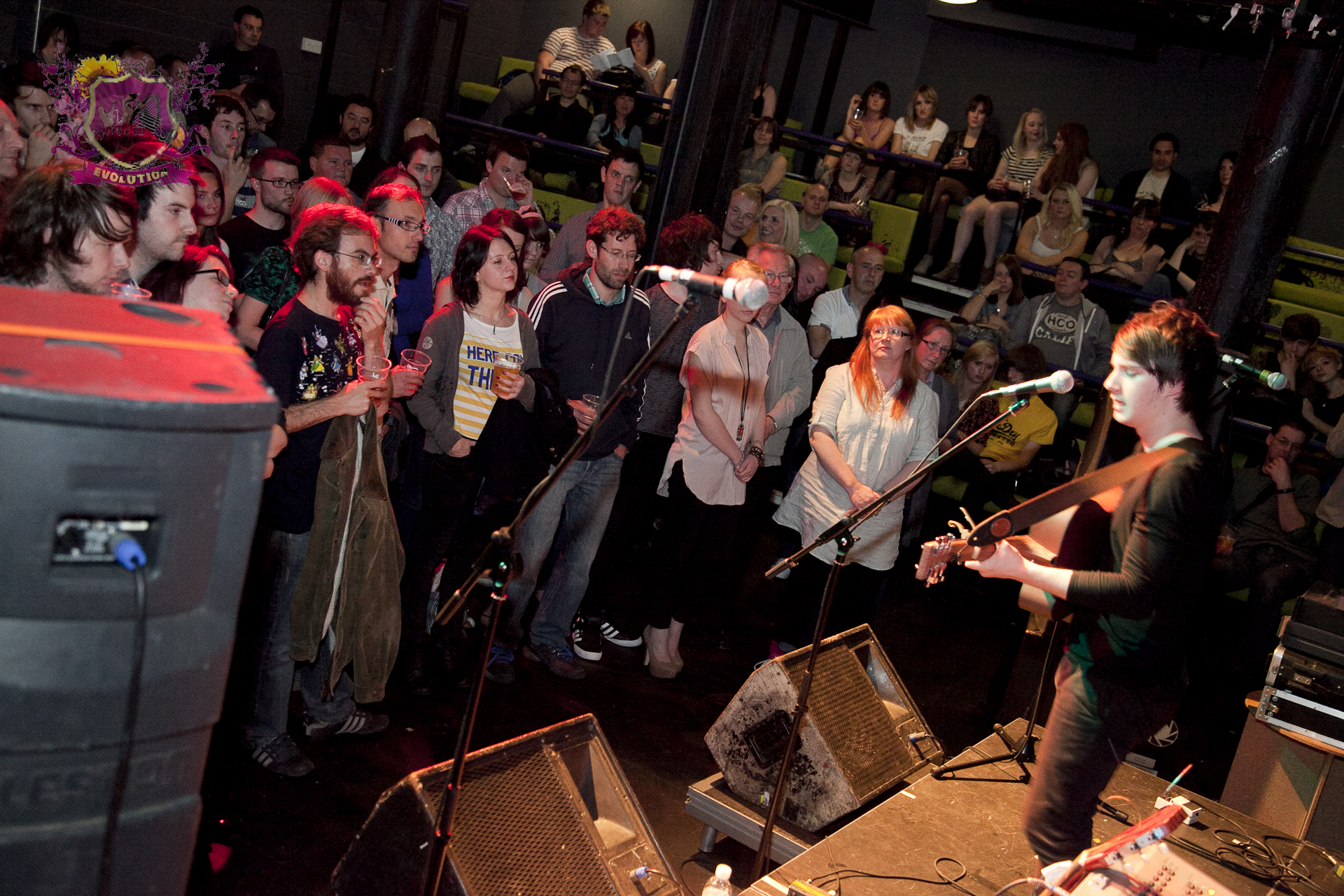 a man standing on top of a stage in front of a group of people