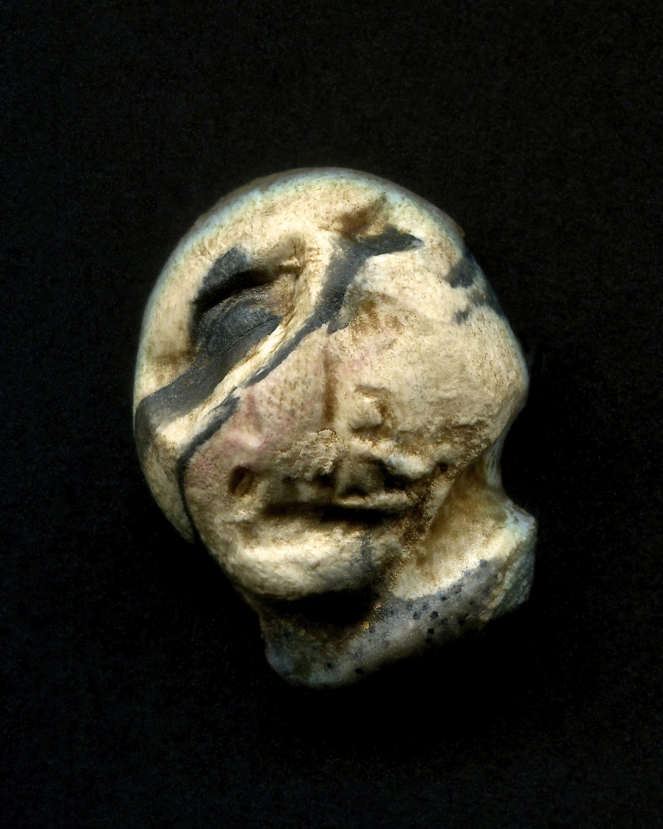 a close up of a ceramic sculpture made of a head