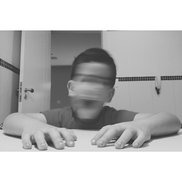 a boy in the bathroom wearing a blindfold