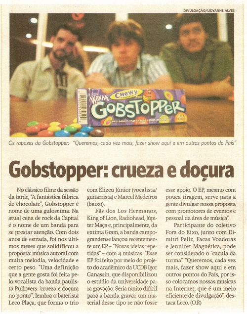 a newspaper article showing two men sitting in front of a bar of candy