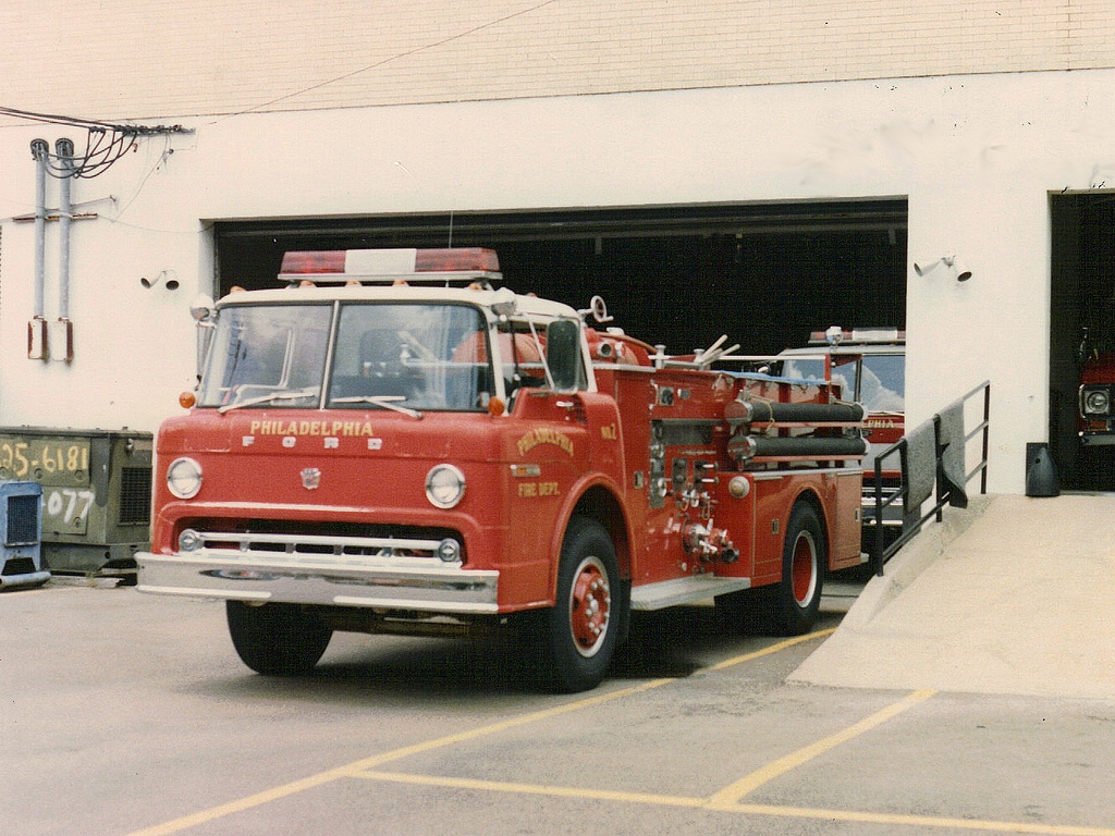 a red fire truck in front of a white building