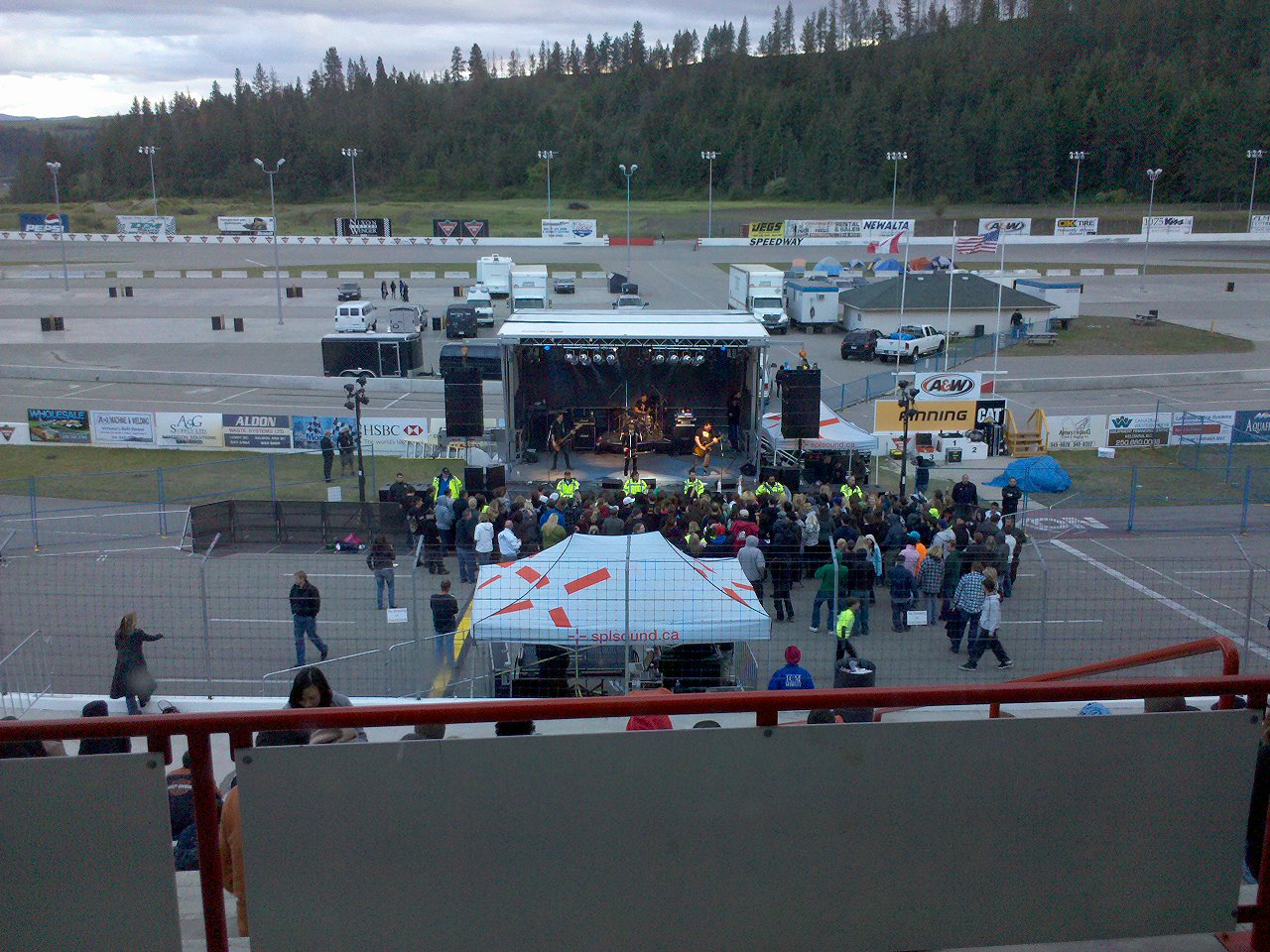 people on the ground near a stage outside of an airport