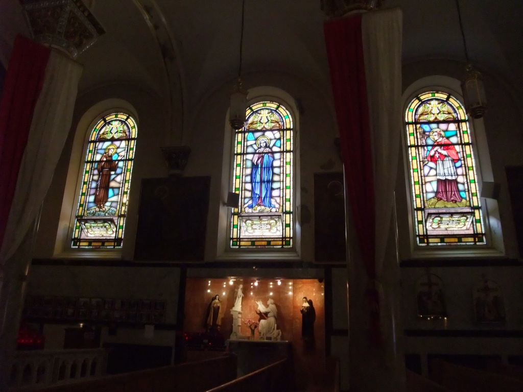 three stained glass windows inside of a church