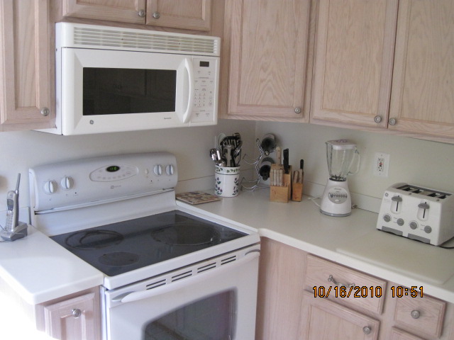 a white stove and microwave oven inside a kitchen