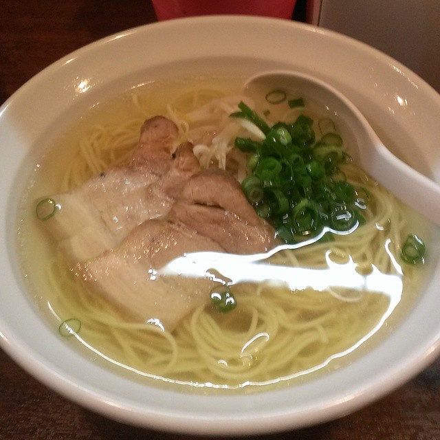 some noodles in soup are displayed inside of a bowl