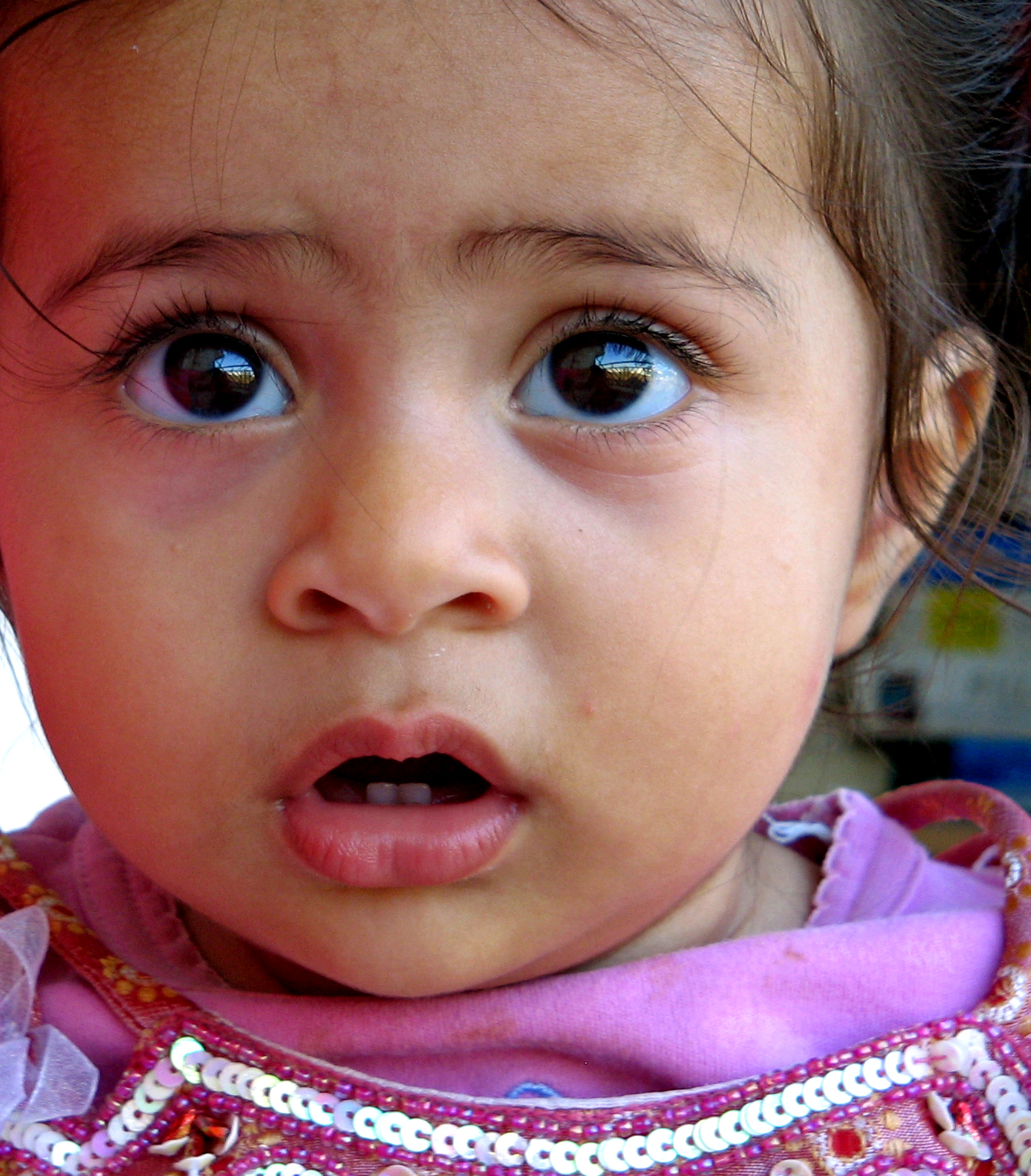 the little girl has a surprised look on her face