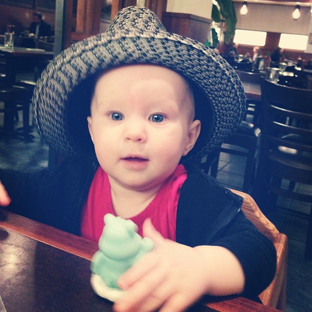 a boy with a hat holding a flower