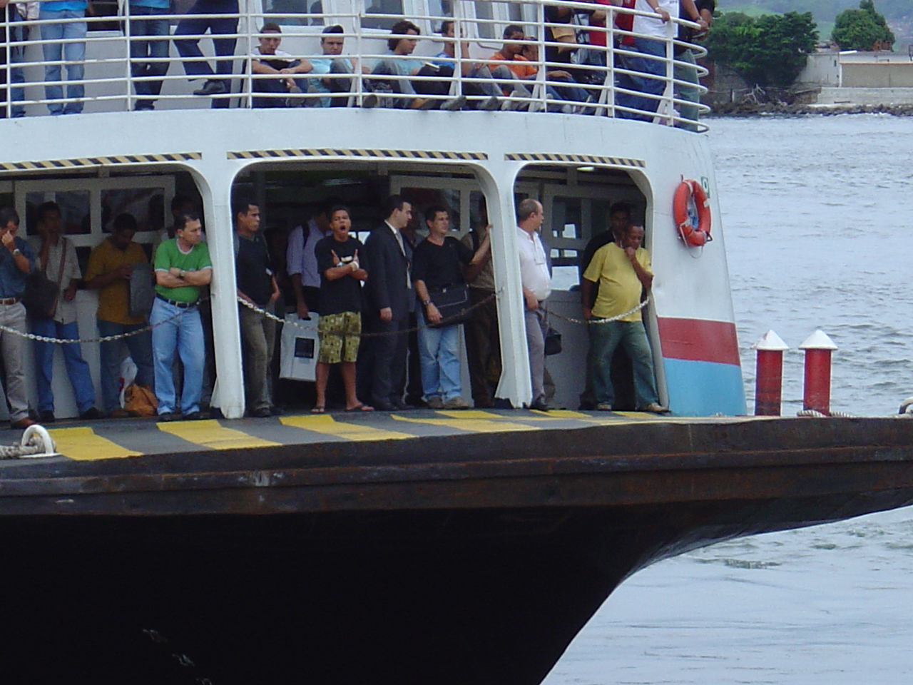 a large crowd of people on the deck of a boat
