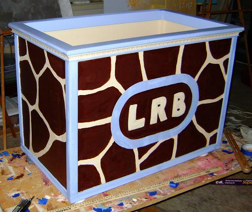 large decorative cube painted in the shape of giraffes