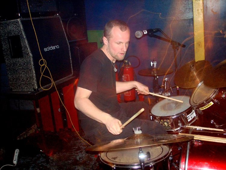 a man playing the drums in a room