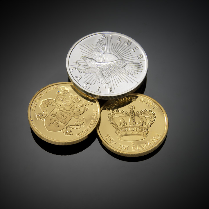 three different pound coins sitting on top of each other