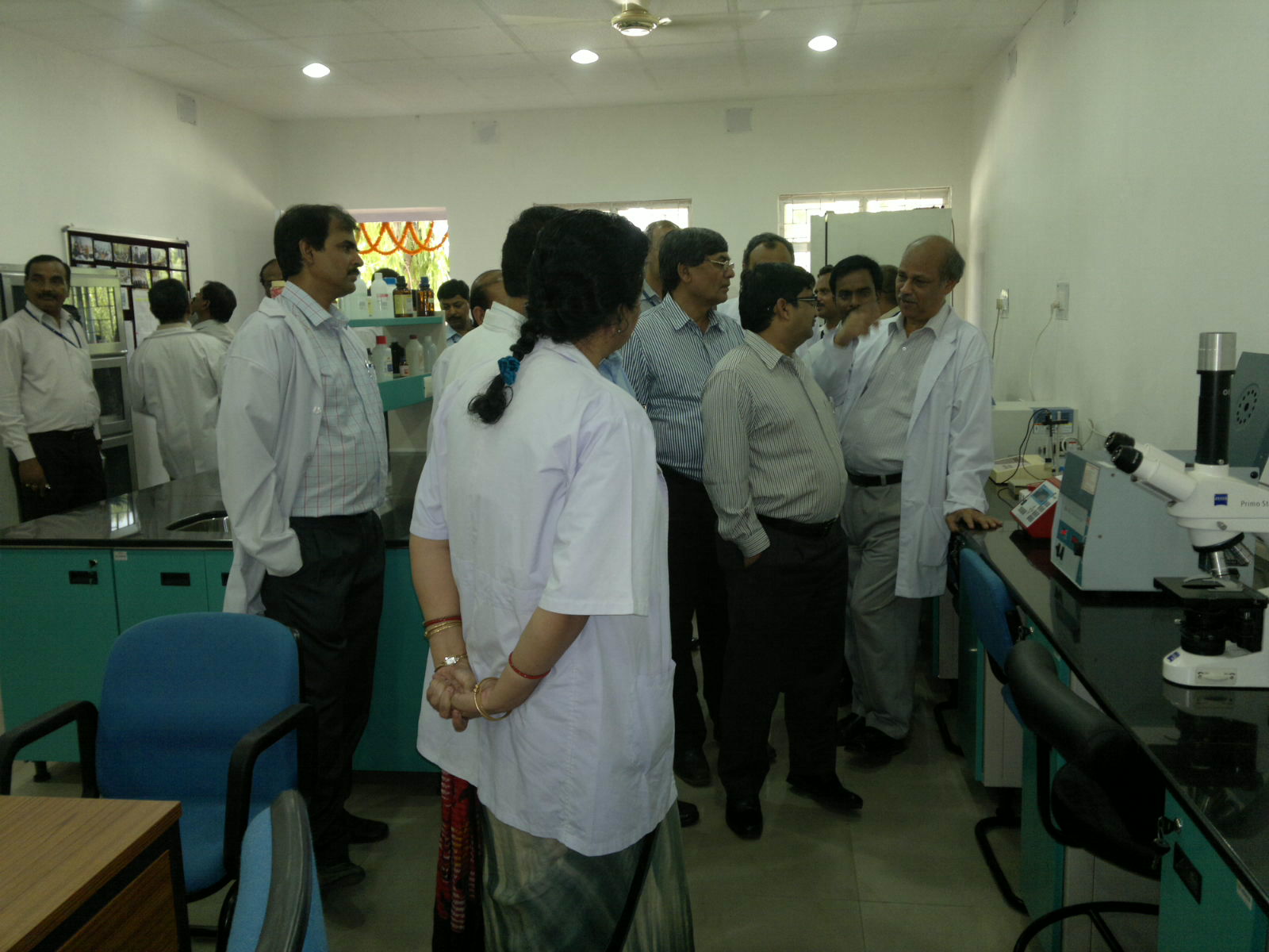 a group of people standing around a lab