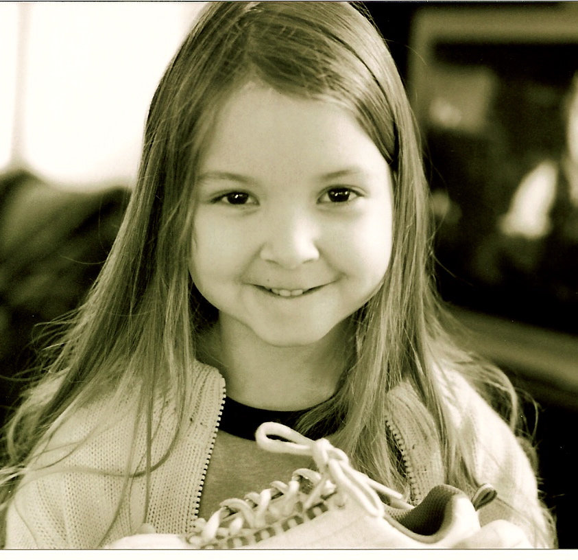 a black and white pograph of a  holding a sneaker