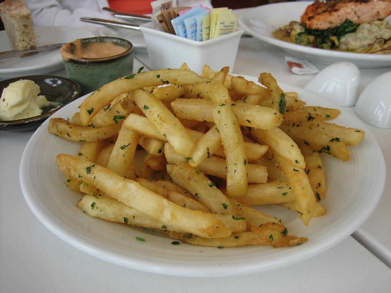 french fries on a white plate with mustard in a saucer