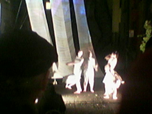 four people watching two dancers on stage