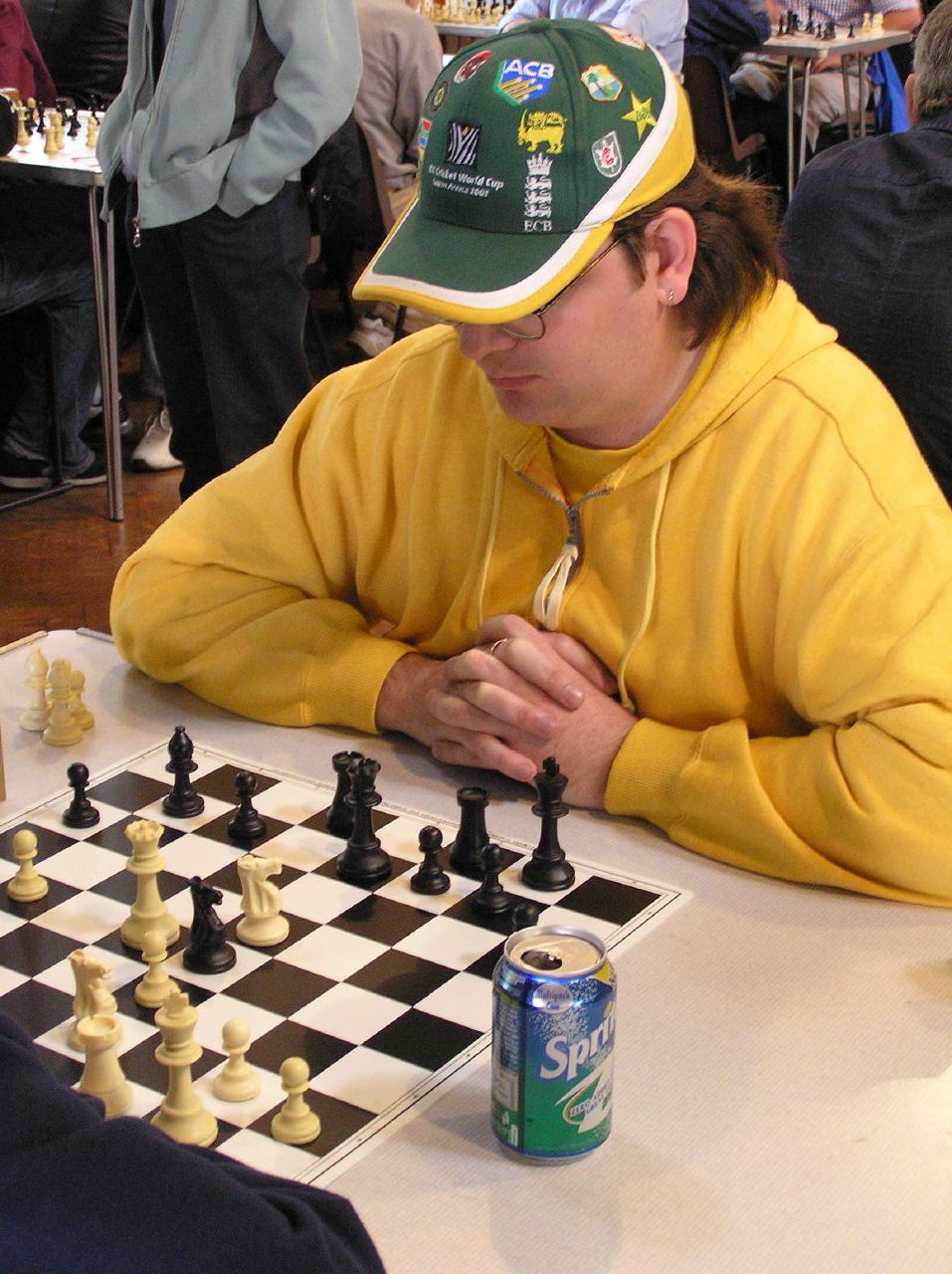 a man is sitting at the table playing a game of chess