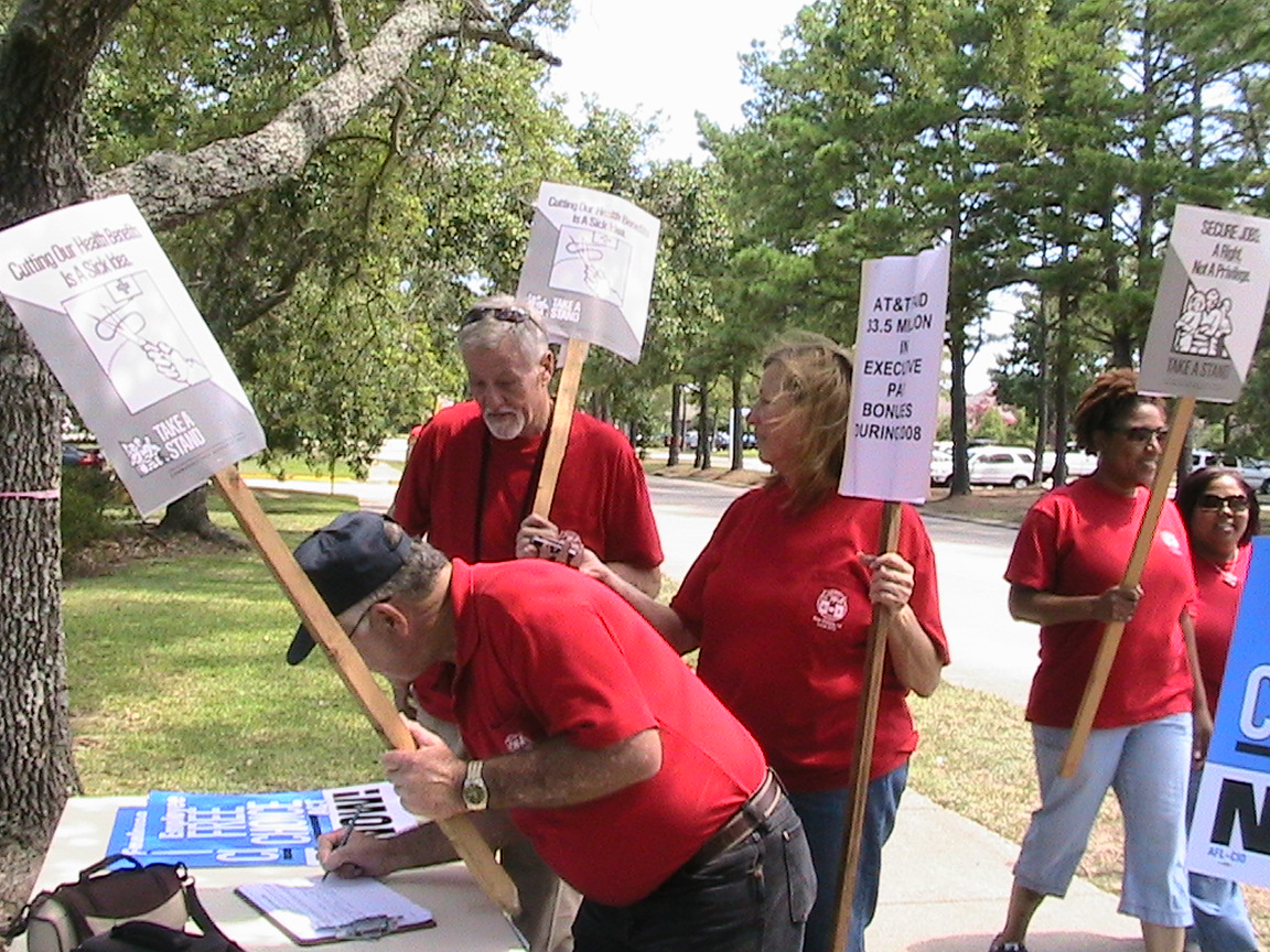 a group of people holding up signs and writing