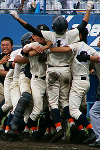 a group of men in white uniforms hugging each other in baseball field