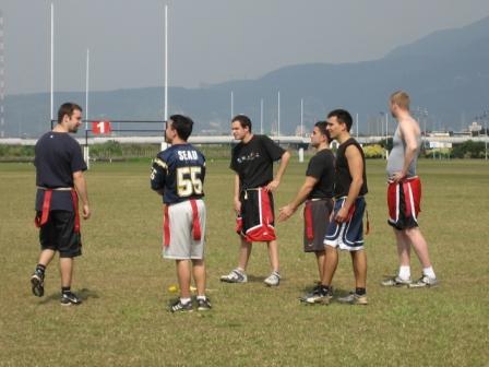 a group of men standing around in a field